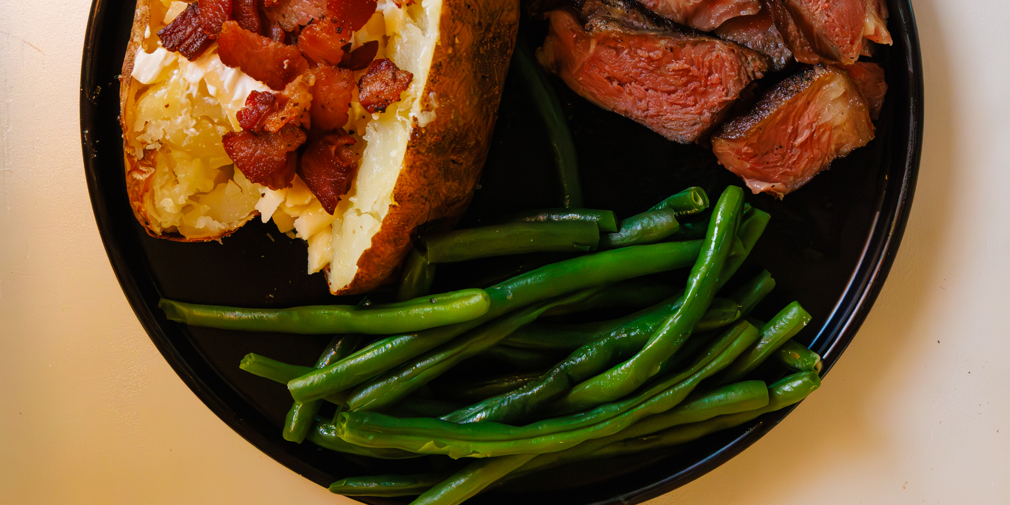 Green beans with steak and baked potato