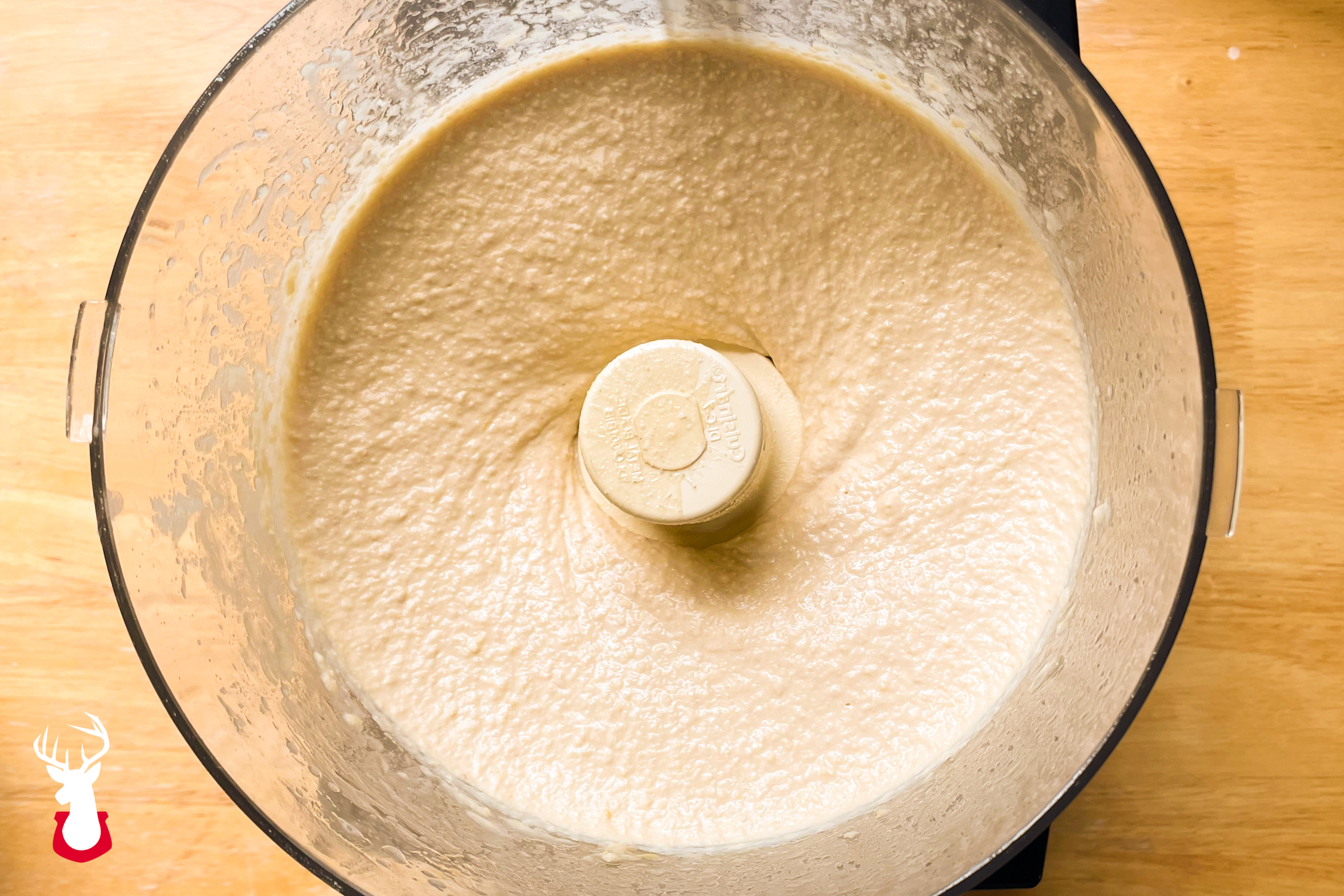 Hummus being blended in a food processor